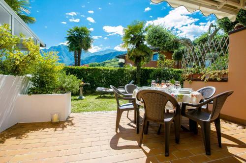 a patio with a table and chairs on a patio at Residence Christina Due Laghi in Tenno