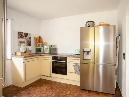 a kitchen with a stainless steel refrigerator at am Wehr Comfortable holiday residence in Allersberg