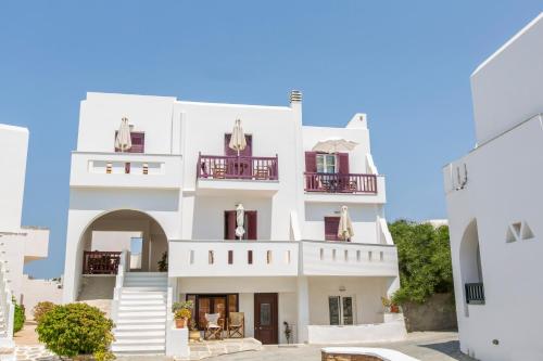 a white building with balconies and stairs at Welcome Naxos in Agios Prokopios