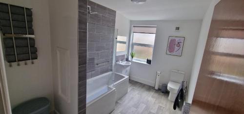 a bathroom with a shower and a toilet and a sink at LFC Anfield Guest House in Liverpool