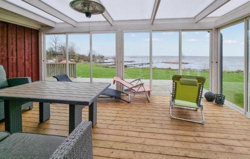 a screened in porch with a table and chairs at 3 Bedroom Pet Friendly Home In Källby in Källby