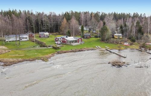an aerial view of a house next to a body of water at 3 Bedroom Pet Friendly Home In Källby in Källby