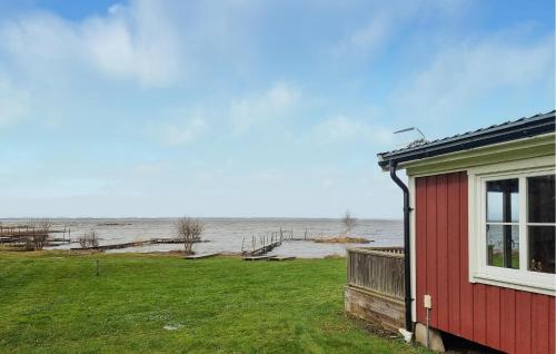 a red house with a view of the water at 3 Bedroom Pet Friendly Home In Källby in Källby