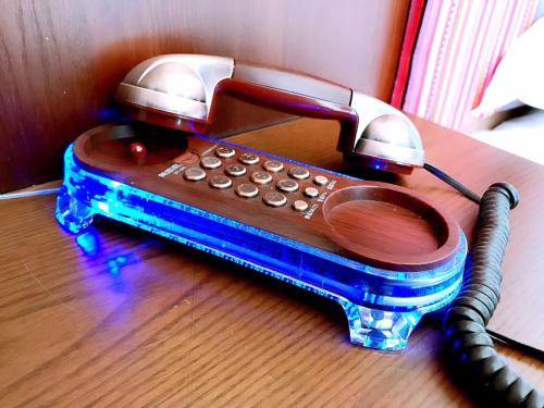 a corded phone sitting on top of a table at Family Hotel Zhangjiajie in Zhangjiajie