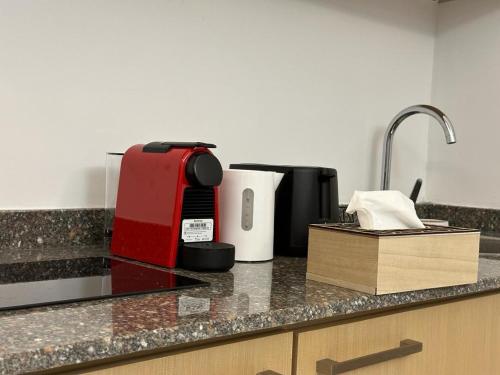 a kitchen with a counter top with a coffee maker at Bark Luxury Appartments @Signal Abidjan Plateau in Abidjan