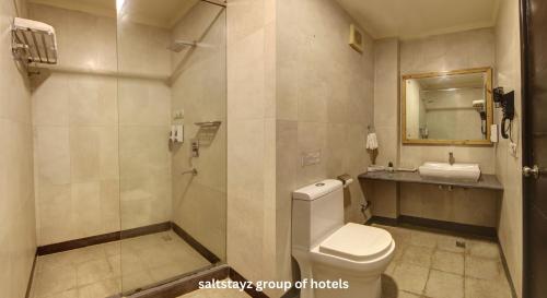 a bathroom with a toilet and a sink at Saltstayz Thyme - New Friends Colony in New Delhi