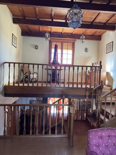 a wooden spiral staircase in a living room at Hotel Pico Espiguete in Alba de los Cardaños