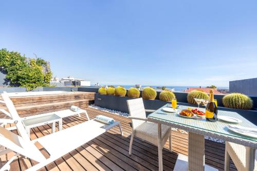 a patio with a table and chairs on a roof at O on Kloof Boutique Hotel & Spa in Cape Town