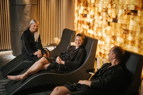 three people sitting in chairs in a room at Tallink City Hotel in Tallinn