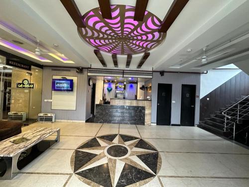 a large lobby with a large purple chandelier at HOTEL COSMOS in Lucknow