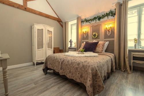 a bedroom with a bed and a window at Le Presbytère de Sévigny in Sévigny-Waleppe