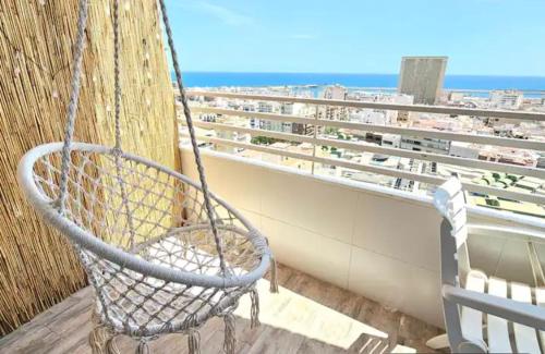 a swing on a balcony with a view of the ocean at Mirador in Alicante