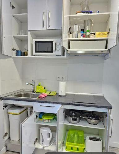 a small kitchen with a sink and a microwave at Mirador in Alicante