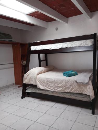 a bedroom with a bunk bed in a room at Los Malvones in Tequisquiapan