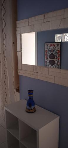 a blue vase sitting on a table in a room at Little Moon in Fontana Liri