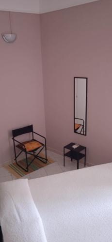 a room with two chairs and a bed and a mirror at Little Moon in Fontana Liri