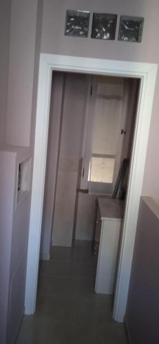 an empty room with a hallway with a door to a kitchen at Little Moon in Fontana Liri