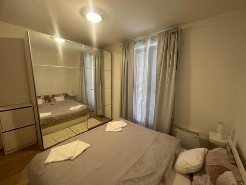 a bedroom with a large mirror and a bed at DunaVera Apartman in Budapest