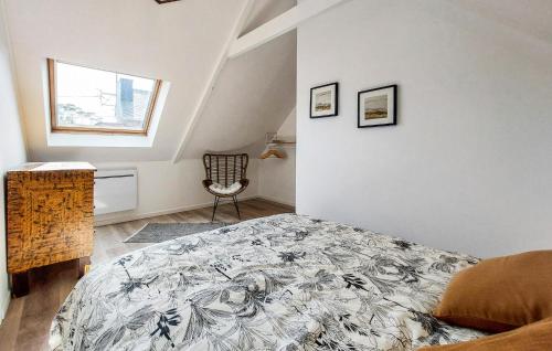 a bedroom with a bed and a chair at 4 Bedroom Amazing Home In Plouézec in Plouézec