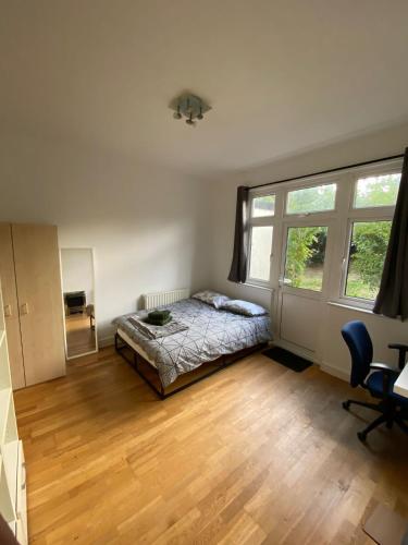 a bedroom with a bed and a large window at [ Mushroom Room ] Double bedroom in NW in Hendon