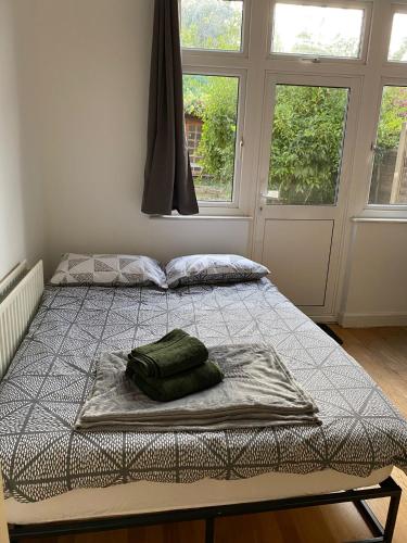 a bed with a blanket on it in a room with a window at [ Mushroom Room ] Double bedroom in NW in Hendon