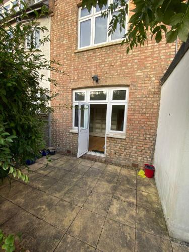 a brick house with a white door and a sidewalk at [ Mushroom Room ] Double bedroom in NW in Hendon