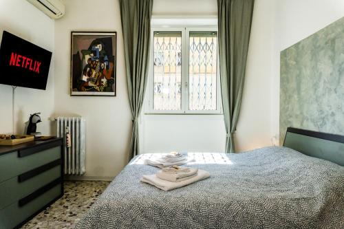 a bedroom with a bed with two towels on it at Pamphili Rooms in Rome