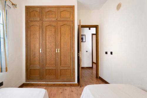 a room with two beds and a wooden door at Casa Rural Tijoco by Paramount Holidays in Adeje