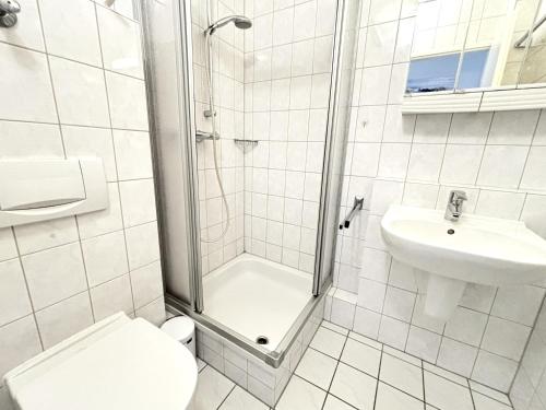 a bathroom with a shower and a toilet and a sink at Ferienpark Sierksdorf App 321 - Strandlage in Sierksdorf