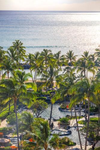 an aerial view of the beach and palm trees at Ko Olina Beach Villas O1006 in Kapolei