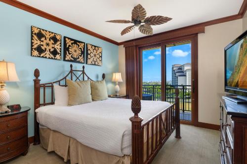 a bedroom with a bed and a balcony at Ko Olina Beach Villas O724 in Kapolei