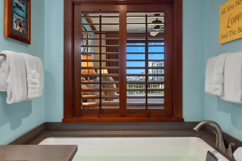 a bathroom with a window over a bath tub at Ko Olina Beach Villas O724 in Kapolei