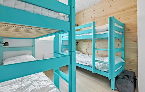 a bunk bed room with blue bunk beds in a cabin at Amazing Home In Glesborg With 5 Bedrooms, Sauna And Indoor Swimming Pool in Tvedhuse