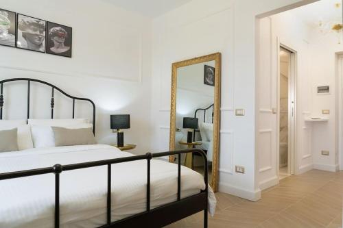 a bedroom with a bed and a mirror at In Villa Apartment in Rome