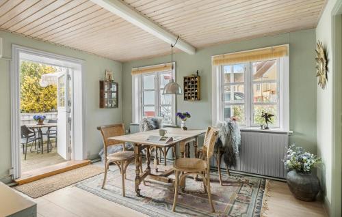 a dining room with a table and chairs at 2 Bedroom Pet Friendly Home In Svaneke in Svaneke