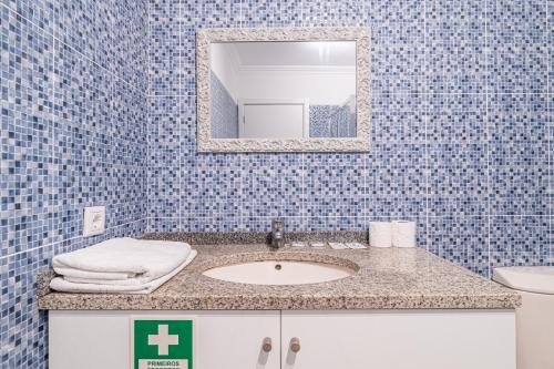 a bathroom with a sink and a mirror at Old Town T1 Apartment in Funchal