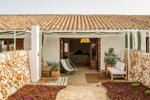 a house with a patio with a bed at Amagatay Luxury Boutique Hotel - Adults Only in Alaior
