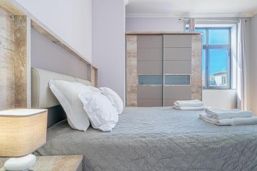 a bedroom with a large bed with white pillows at Old Town T1 Apartment in Funchal