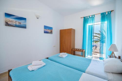 a bedroom with two beds and a window at MYLOS (6) in Chania