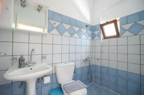 a blue and white bathroom with a toilet and a sink at MYLOS (6) in Chania