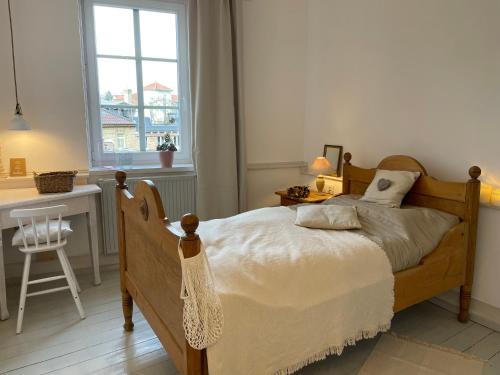 a bedroom with a bed and a desk and a window at Altstadt-Gästehaus mit Garten. Und Herz. in Bad Kreuznach