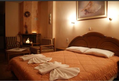 a bedroom with a bed with two towels on it at 4 MOUNTAIN HILLS in Megalo Chorio