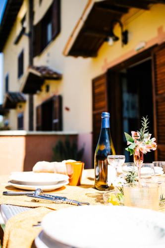 a table with a bottle of wine and plates on it at Selvicolle Country House in Crispiero