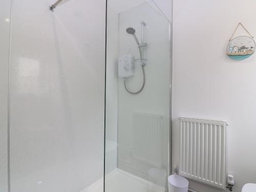 a shower with a glass door in a bathroom at 2 College Bounds in Fraserburgh