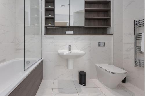 a white bathroom with a sink and a toilet at Greengate in Manchester
