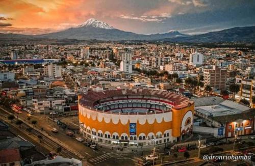 a city with a soccer stadium and a mountain at Suite Privada Riobamba in Riobamba