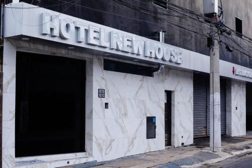 a building with a sign on the side of it at Hotel New House in Sao Paulo