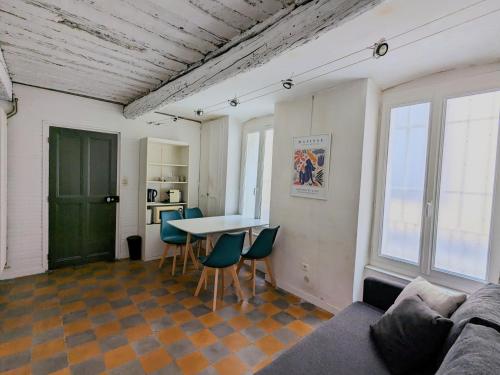 un salon avec un canapé, une table et des chaises dans l'établissement Cozy Apartment Intramuros near the Station, à Avignon