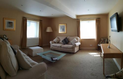 a living room with a couch and a table at The Trouville Bournemouth in Bournemouth