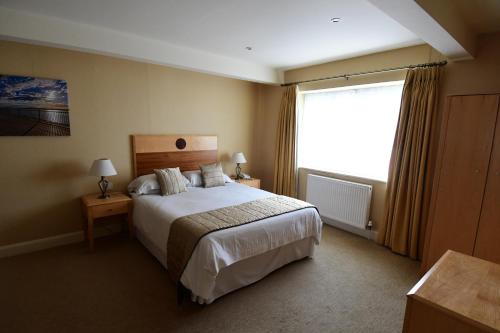 a hotel room with a bed and a window at The Trouville Bournemouth in Bournemouth